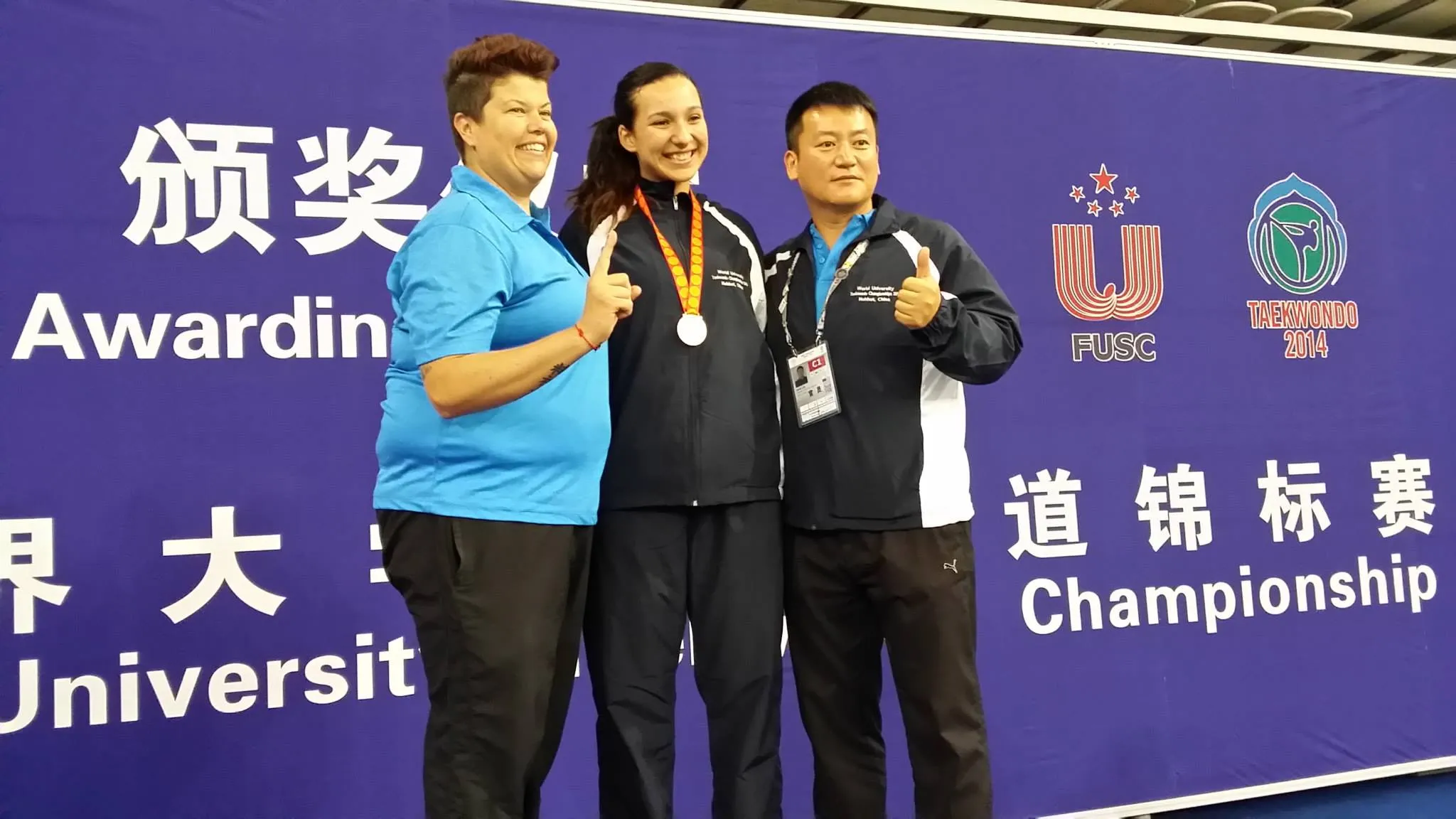 A medalist on the podium at the 2014 World University Taekwondo Championships